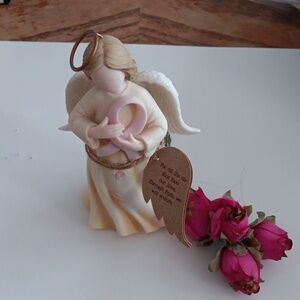 New - Angel Statue About 5 inches long. Pink ribbon for breast cancer awareness.
